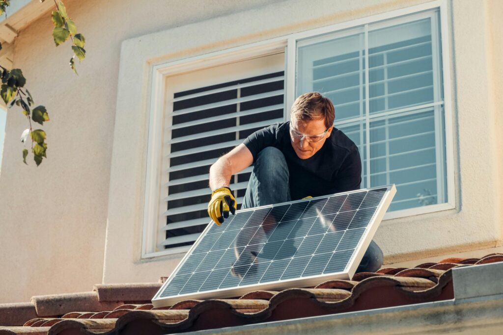 Professional solar panel installation in Los Angeles – technician installing a solar panel on a residential rooftop.