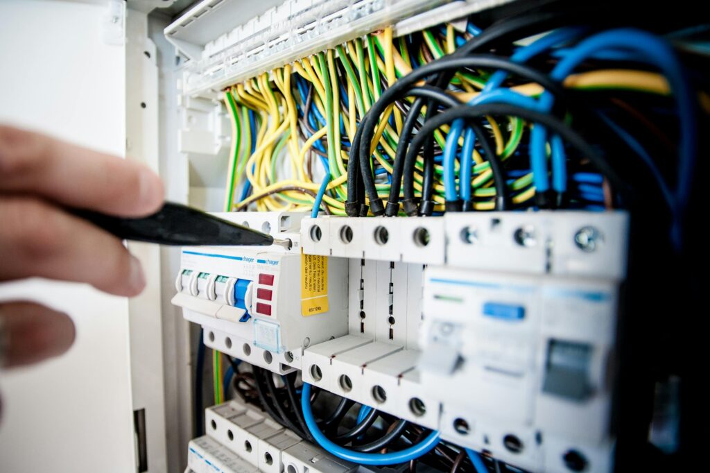 Close-up of an electrical panel with complex wiring, demonstrating the technical setup involved in a professional solar panel installation.