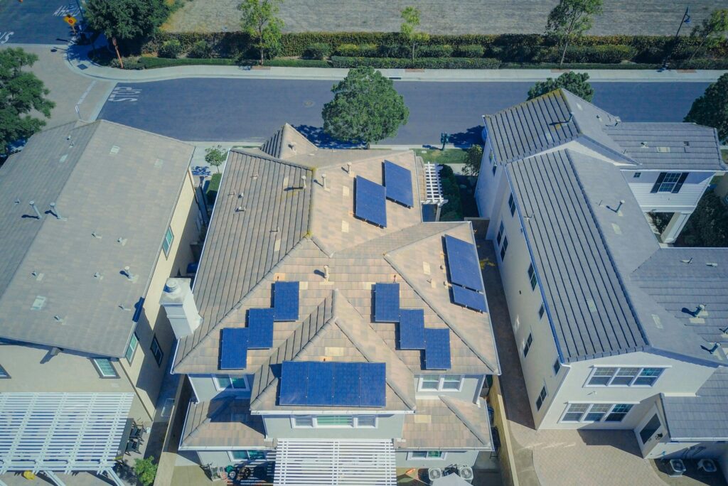 Aerial view of a modern home in Los Angeles with a rooftop solar panel system, highlighting the benefits and savings of solar panels installation cost for homeowners